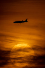 Silhouette of passenger airplane with the morning sunrise background