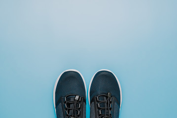 The concept of running sport, running shoes for fitness on a blue background,the minimalist symbol of a healthy lifestyle,copy space,top view
