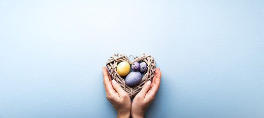 Naturally colorful dyed Easter eggs on blue background	