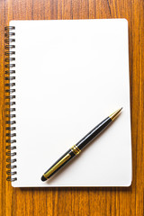 close up opening note paper and pen on wood texture background with copy space