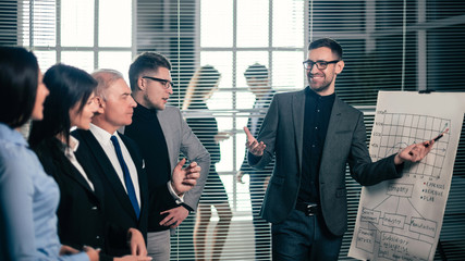 project Manager pointing to a flipchart with a schedule