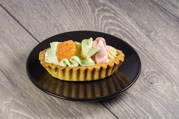 Basket of puff pastry with multi-colored cream for children's treats.