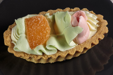 Basket of puff pastry with multi-colored cream for children's treats.