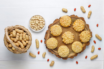 Homemade crunchy cookies with peanuts on white wooden background,top view