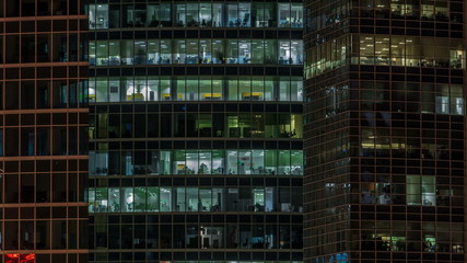 Close up view to office windows in Skyscrapers Moscow-City at night timelapse from top, Moscow, Russia 4K