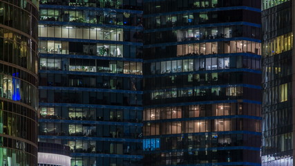 Close up view to office windows in Skyscrapers Moscow-City at night timelapse from top, Moscow, Russia 4K