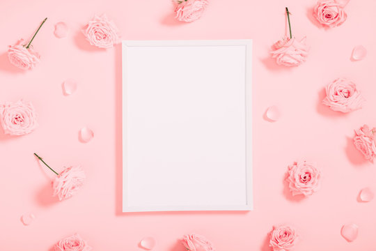 Beautiful flowers composition. Blank frame for text, pink rose flowers on pastel pink background. Valentines Day, Easter, Birthday, Happy Women's Day, Mother's day. Flat lay, top view, copy space