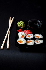 Set of sushi in box on black background