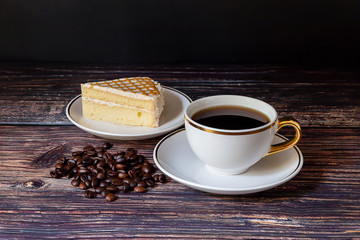  Black coffee in white cups and cakes Placed on a black wooden table