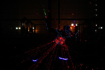 multi-colored laser beams. man laserboy. laser lines in the dark