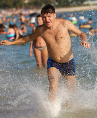 A man runs on the water on the seashore