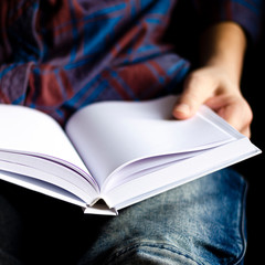 White book with clean pages in the hands of a man