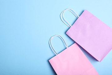packages for shopping on a colored background top view. Minimalism, place for text.