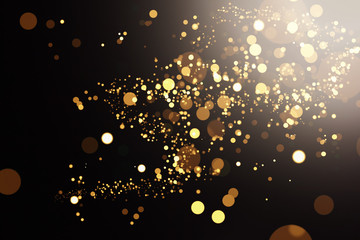 Golden defocused lights over black background