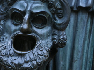 bronze tragic mask a symbol of the inevitability of punishment of a person violating the will of...