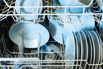 Open dishwasher with clean dishes. Clean glasses after washing in the dishwasher.
