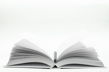 Mockup of closed blank square book and black pencil at white textured paper background