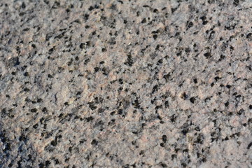 Macro texture of white granite with black splashes