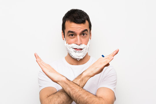 Man Shaving His Beard Over Isolated White Background Making NO Gesture