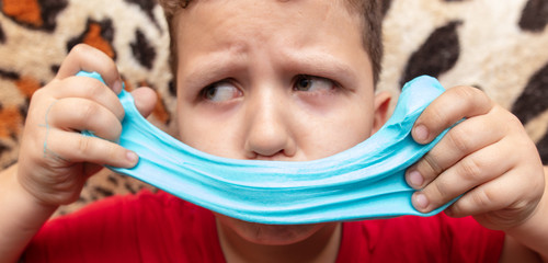 The boy stuck a slime on his face.