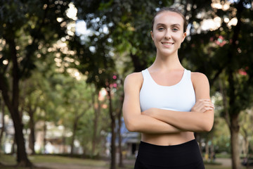 Fototapeta premium healthy happy strong fitness woman works out; concept of woman with healthy lifestyle, health care, body care, confident fitness people in fresh air and green environment; white caucasian woman model