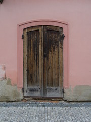 Old wooden door pink walls