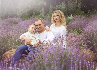 Fototapeta premium happy family with boy relax in lavender field in summer