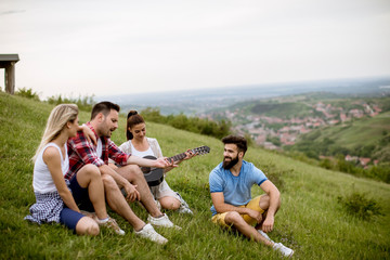 Group od young people having fun on a field trip in nature on a mountain