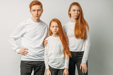 group of young, attractive caucasian people with natural red hair gathered together in studio with white background.redhead day. rare type of people with natural red hair. people diversity