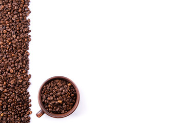 a Cup of coffee and coffee beans on an isolated background close up view from the top