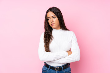 Young woman over isolated pink background with confuse face expression