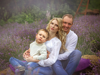 Fototapeta premium happy family with boy relax in lavender field in summer