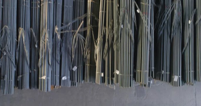 Metal round billets in a warehouse, metal in an indoor warehouse, span over metal in a warehouse
