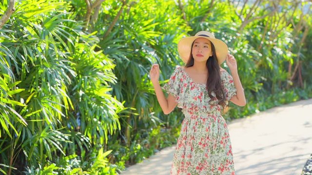 Asian travel influencer posing with joy on a vacation, medium shot 