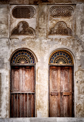Fototapeta na wymiar two windows from an old house, old city Bahrain