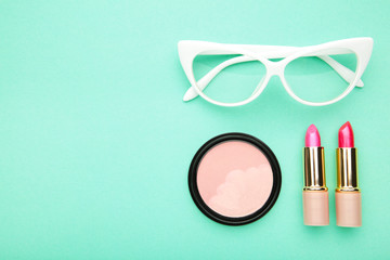 Makeup set on mint background, top view. Cosmetics