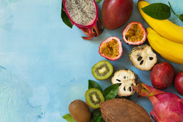 Fruit background. Assorted ripe juicy Exotic asia summer seasonal fruits on a blue stone...