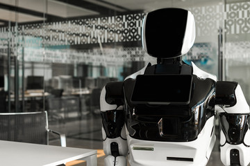 humanoid robot standing in conference hall of modern office