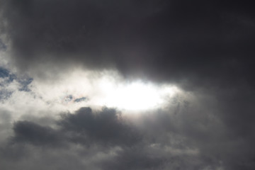 The rays of the sun making their way through rain clouds