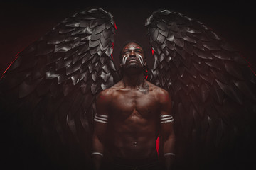 young strong black angel with cool wings, stand posing at camera. man fall from heaven, angel with...