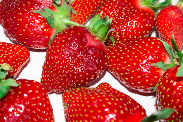 Closeup of a large ripe juicy strawberry on a white background