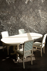 A set of furniture for the kitchen in the loft interior. A collection of chairs and tables for dinner in the family circle.
