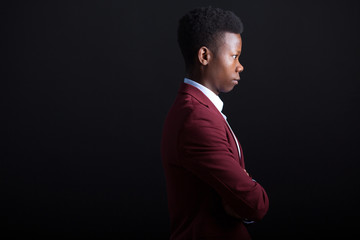 handsome young african man in suit on black background