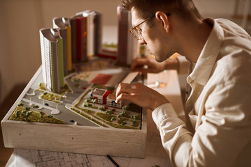 young handsome man developing area, district, close up side view photo. architect working with a...