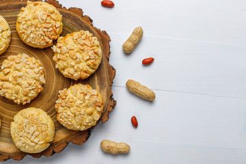 Homemade crunchy cookies with peanuts on white wooden background,top view