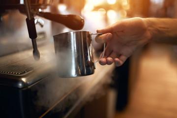 Fototapeta na wymiar man preparing coffee on steam espresso working machine, close up side view photo.Step by step skills of coffee making