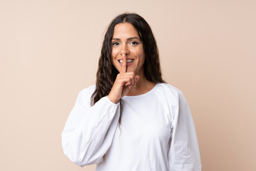 Young woman over isolated background doing silence gesture
