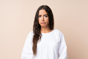 Young woman over isolated background sad