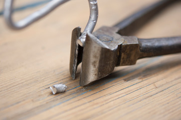 Old iron nippers on wood background