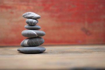 Stack of stones on wooden table, space for text. Zen concept
